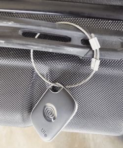 steel cable securing luggage tracker
